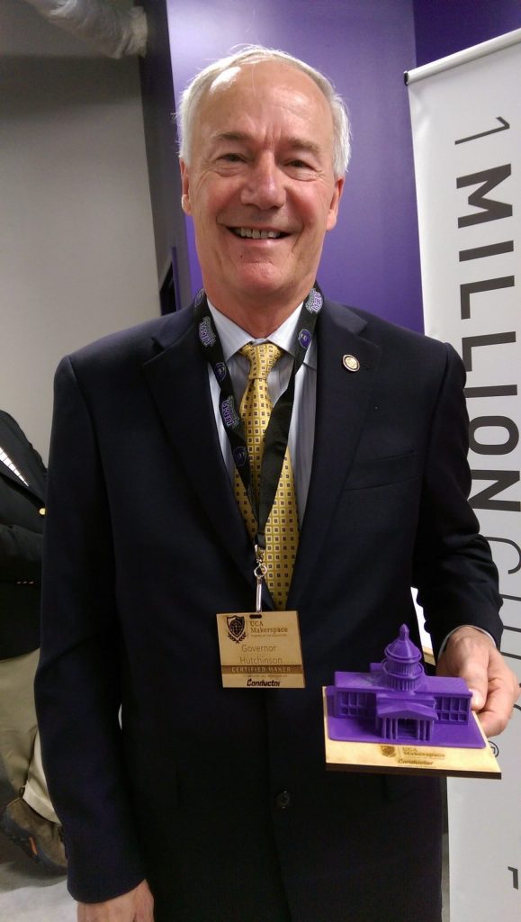 Governor Huthchinson shows off his gifts from the Makerspace