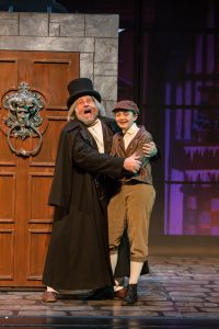 Scott H. Severance as Ebenezer Scrooge and young cast member