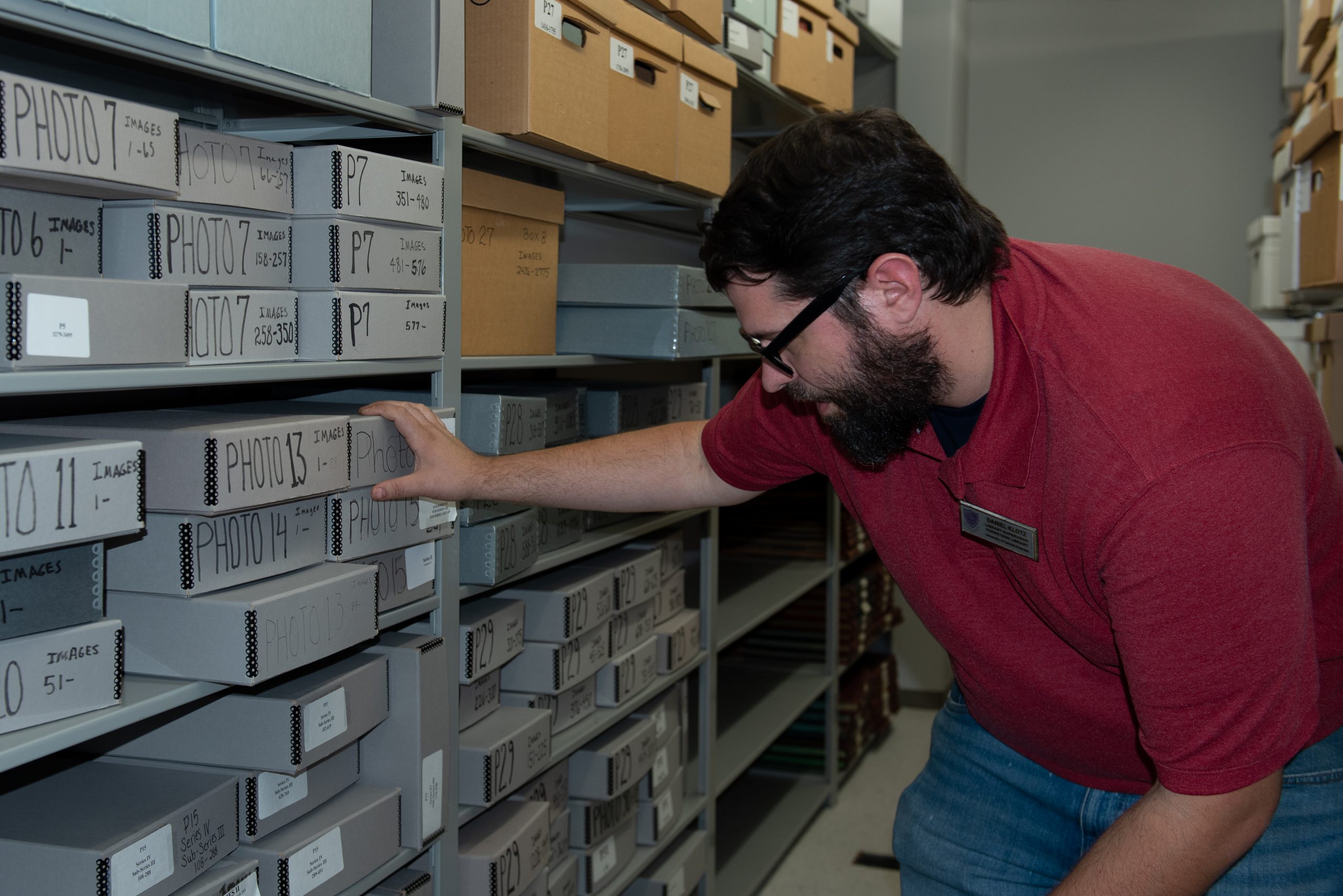 Daniel Klotz, UCA interim archivist, sorts through photos in the UCA Archives.